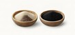 © Destri - Two wooden bowls with beige and black powder inside, isolated on white background