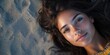 © kwanchaift - A striking portrait of a beautiful woman lying on the sandy beach.