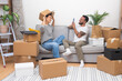 © olga_demina - Loving couple collects various cardboard boxes for moving in new flat together remembering pleasant moments in old house taking memorable photos with positive emotions