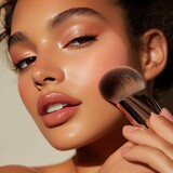 Close-up of a woman using setting powder and blush for a flawless finish