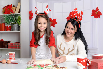 Mom and daughter are preparing New Year's cakes.