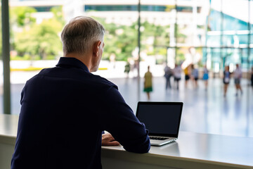 Man working on laptop in a modern office environment