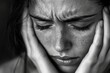 © aiLover - A close-up monochrome portrait of a young woman expressing deep emotional distress Her hands clutch her head, revealing intense feelings of anxiety and introspection