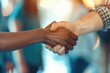 © LukaszDesign - Business professionals come together in a corridor to discuss partnership, engaging in a handshake to symbolize collaboration and teamwork