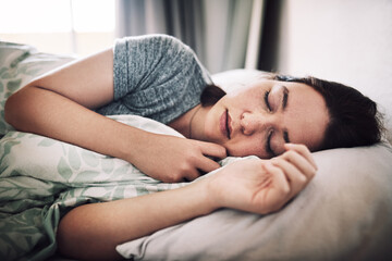 Wall Mural - Woman, tired and sleeping in house for nap, relax and exhausted with peace, comfort and weekend rest in bed. Female person, fatigue and asleep in bedroom for break, morning and burnout with pillow