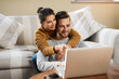© Chanelle2000/peopleimages.com - Laptop, planning and relax with couple in living room for investment portfolio, application and bank loan. Future, technology and partnership with man and woman in home for real estate research