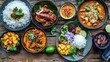 © วรรณภา มะโนศรี - Colorful Thai feast with dishes like massaman curry, crispy pork belly, and mango sticky rice, all beautifully presented on a rustic wooden table