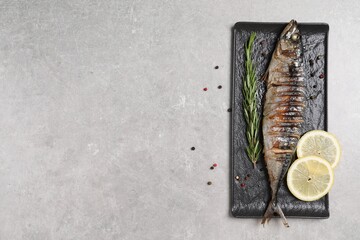 Canvas Print - Delicious grilled mackerel, rosemary, lemon and peppercorns on grey table, top view. Space for text