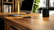 © Nima - A clean and organized modern office desk with a beautiful woodgrain top, featuring a computer monitor, a keyboard, a smartphone, and a pencil holder. The desk exudes a sense of productivity and style.