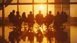 © aref - A group of people are sitting around a table in a conference room