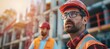 © spyrakot - Experienced Worker Discussing with Foreman at Construction Site - Industrial Work Environment