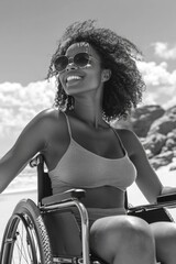 Poster - A woman in a wheelchair is smiling and wearing sunglasses. She is sitting on the beach and she is enjoying herself