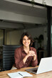 © insta_photos - Vertical portrait of confident businesswoman leader in her 30s at work desk. Smiling Hispanic young woman entrepreneur, happy female executive manager looking at camera sitting at work with laptop.