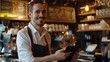 © Ева Поликарпова - A person standing in front of a bar, holding a tablet and possibly looking at it