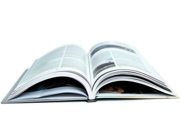 A person is reading from an open book placed on a clean and tidy white surface