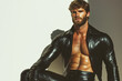 © Augustino - Famous Gay, Queer Art concept. Portrait of a handsome biker bodybuilder with beard wearing black leather clothing, posing on white background. Text space. Studio shot