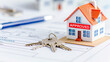 © Creative Habits - Model house with approved stamp and keys on paperwork for real estate transaction