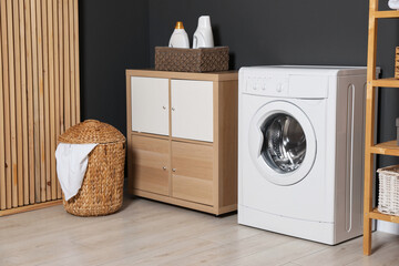 Sticker - Washing machine, detergents, laundry basket and storage cabinet indoors