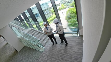 Poster - Aerial view of multinational engineers talking in the lobby