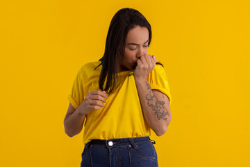 Young beautiful woman in shirt with the yellow color of Brazil in studio photo with various expressions of feelings