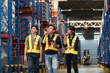 © amorn - Asian warehouse workers inspecting of product on shelf in storage warehouse. Group of warehouse workers discuss and training work in distribution branch