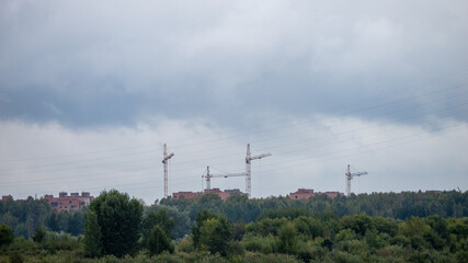 A cloudy sky with a few tall buildings in the background