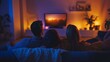 © Arora Chan - An LGBTQ+ family cuddled on the couch watching TV together, creating a warm, intimate atmosphere with soft lighting and cozy blankets