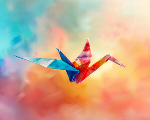 A beautiful origami bird flies through the sky. The bird is made of blue, orange, and yellow paper. The sky is a gradient of blue and orange.