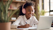 © PREM - a black smiling girl student studying on laptop, online study, e-learning