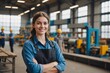 © ThomasLENNE - Confident smiling young female worker posing with crossed arms in glass factory, against blurred background of workshop setting, showcasing professionalism and pride in job