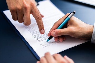 Wall Mural - Pointing The Finger In Front Of A Person Signing With Golden Pen On The Document