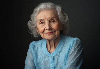 Canvas Print - Studio portrait of an elderly woman in a blue blouse, looking at the camera