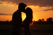 © evening_tao - Romantic Silhouette of Couple Kissing at Sunset