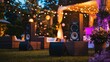 © Seak - Elegant outdoor event with large, beautifully designed speakers set up to amplify soft background music, surrounded by tasteful decor and ambient lighting