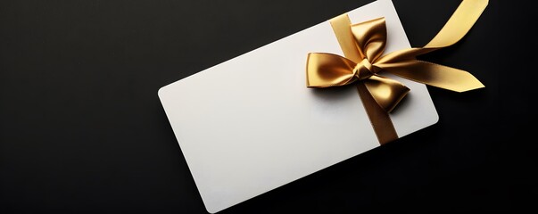 white gift card with gold ribbon bow