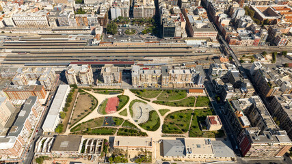 Aerial view of the train station in Bari, Puglia, Italy. In foreground is Rossani Park, a square city park built in a residential area.