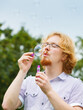 © Voyagerix - Man blowing soap bubbles, having fun