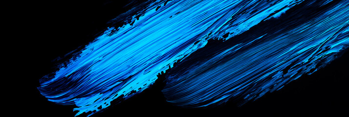 Wall Mural - bright blue brush stroke of paint on black background