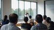 © VistaVisions - Blurred speaker lecturer at business convention and presentation in background, rear view of audience participants in lecture hall convention center workshop