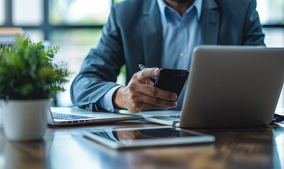 Poster - middle-aged professional man using smartphone, laptop, tablet on desk - busy office work, business m