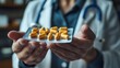 © Рудой Максим - Medical professional presents a tray of yellow capsules in a clinical setting during a patient consultation for health advice