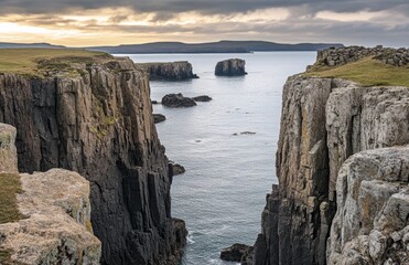 Wall Mural - Majestic cliffs border a tranquil sea, with distant rocky islands illuminated by the warm glow of sunset in a remote coastal area