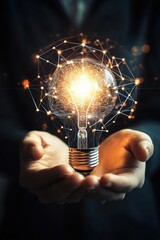 Poster - business professional holding an illuminated light bulb representing innovation and new ideas in a d