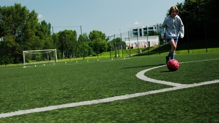 Wall Mural - Small Girl Playing Soccer Ball During Practice