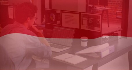 Poster - Animation of flag of indonesia over caucasian businessman using laptop