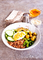 Sticker - Bowl of tasty buckwheat porridge and egg on table