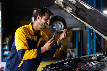 spark plug inspection. Hispanic latin man professional mechanic repairs car working in garage. Car maintenance and auto service garage concept