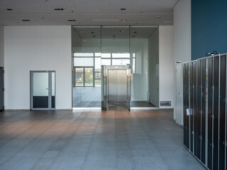 Poster - Business center foyer without anyone. Office building with storage cells. Interior business premises corridor. Foyer administrative building with entrance to elevator. Business center interior