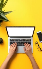 Poster - Person typing on laptop with white screen, surrounded by plants and office essentials on a vibrant yellow desk