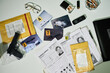 © pressmaster - Collection of crime scene evidence on an office desk includes photographs, cigarette butts, glasses, handgun, and criminal profiles laid out systematically